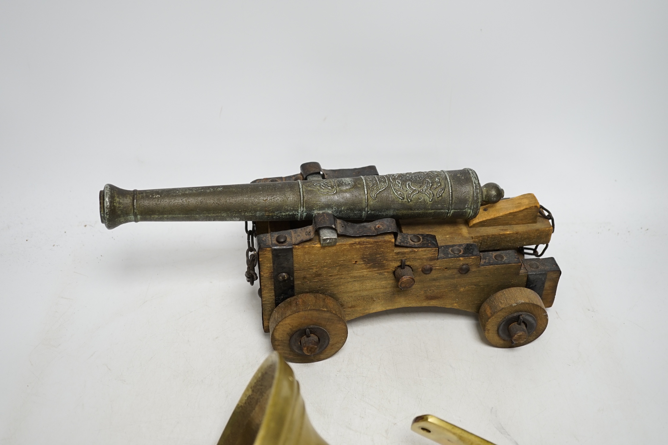 A brass ship's bell and a model cannon, largest 36cm wide. Condition - fair